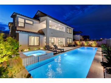 Inviting backyard featuring a pool, spa, and lounge area, perfect for outdoor entertaining at 472 Windstone Crest Ave, Las Vegas, NV 89138