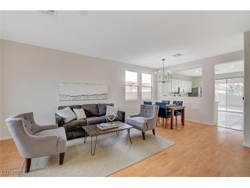 Inviting living room boasts stylish seating and seamless flow to the dining area, perfect for entertaining at 5033 Wild Buffalo Ave, Las Vegas, NV 89131