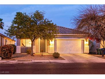 Charming single-story home featuring a well-manicured front yard and an attached two-car garage at 5332 Polo Grounds St, Las Vegas, NV 89148