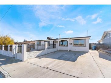 Charming single-story home featuring a gated front yard and a spacious driveway at 6425 Evergreen Ave, Las Vegas, NV 89107
