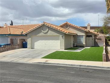 Charming single-story home with a two-car garage and well-maintained artificial lawn at 7091 Rhapsody Ln, Las Vegas, NV 89119