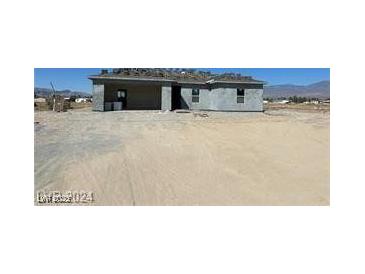 Unfinished single-story home exterior featuring block construction and an expansive lot at 970 Mount Charleston Dr, Pahrump, NV 89048