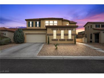Charming two-story home with a desert landscape, neutral color palette, and a barrel tile roof at 489 Wendover Hills Ave, Las Vegas, NV 89123