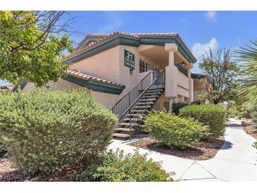 Exterior view of a multi-Gathering residential building featuring lush landscaping and stairwell at 8410 Eldora Ave # 2045, Las Vegas, NV 89117