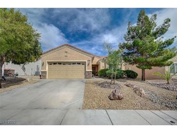 Charming single-story home featuring a well-manicured front yard and a spacious two-car garage at 7460 Chaffinch St, North Las Vegas, NV 89084