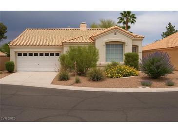 Charming single-story home with a two car garage, desert landscaping and a tile roof at 9532 Calico Garden Ave, Las Vegas, NV 89134