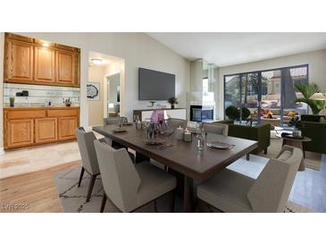 Open-concept dining area with sleek table, seating for six, bar, and views of the outdoor living space at 2723 Seabridge Dr, Las Vegas, NV 89121