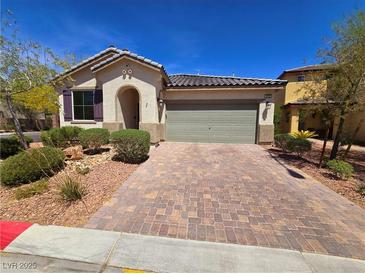 Charming single story home with a welcoming entrance, brick driveway and a two-car garage at 4032 Little Bay Ave, North Las Vegas, NV 89081