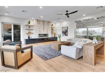 Bright living room featuring a modern fireplace, sleek furniture, and ample natural light at 211 Granite Ct, Boulder City, NV 89005