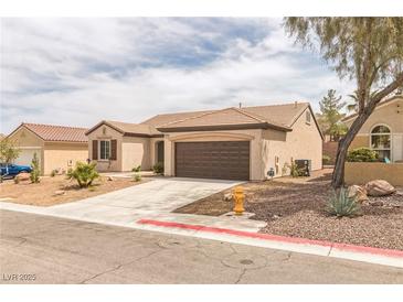 Charming single-story home featuring desert landscaping and a two-car garage at 2605 Memphis Ave, Henderson, NV 89052