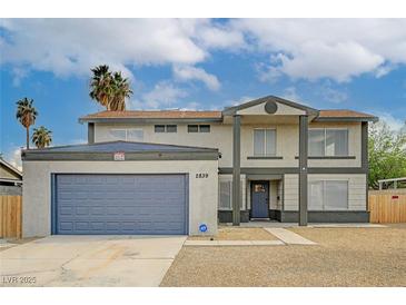 Inviting two-story home featuring a large garage, desert landscaping, and a covered front entryway at 2839 Boise St, Las Vegas, NV 89121