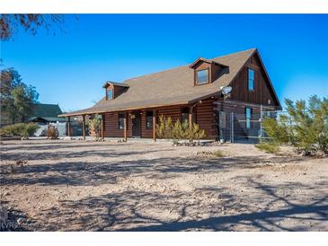 Charming log cabin-style home with a covered porch, offering rustic charm and outdoor living space at 3900 W Landberg Ave, Las Vegas, NV 89141