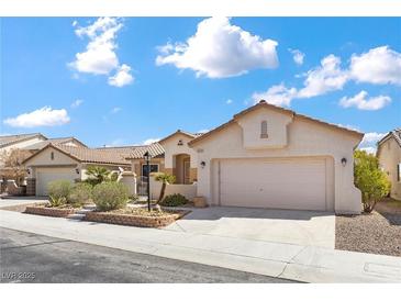 Charming single-story home showcasing desert landscaping and a two-car garage at 4416 Peaceful Morning Ln, Las Vegas, NV 89129