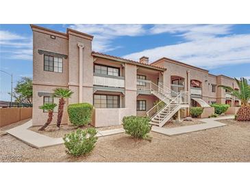 Condominium exterior with multiple levels and decorative landscaping in desert environment with stairs leading to units at 5170 S Jones Blvd # 205, Las Vegas, NV 89118