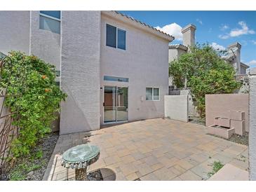 Relaxing outdoor patio featuring pavers, plants, and a quaint glass table with a serene ambiance at 5331 Heatherbrook Cir, Las Vegas, NV 89120