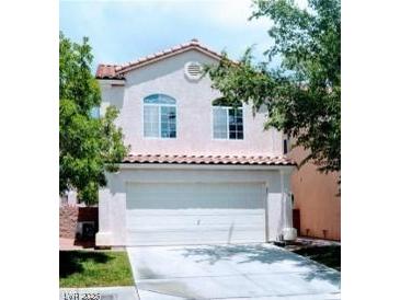 Charming two-story home featuring a spacious two-car garage and well-maintained landscaping at 5811 Pack Trl, Las Vegas, NV 89118