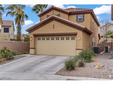 Charming two-story home featuring a two-car garage and desert landscaping at 651 Penshaw Bridge Ave, Las Vegas, NV 89178