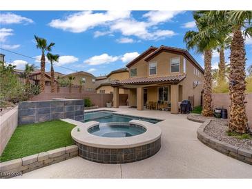 Resort-style backyard featuring a sparkling pool and spa, perfect for outdoor relaxation and entertaining at 651 Penshaw Bridge Ave, Las Vegas, NV 89178