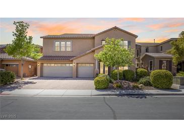 Charming two-story home featuring a three-car garage and beautifully landscaped front yard at 6917 Puetollano Dr, North Las Vegas, NV 89084