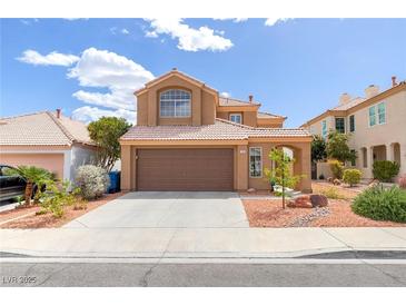Charming two-story home with a well-manicured lawn and a two-car garage at 7905 Coral Point Ave, Las Vegas, NV 89128