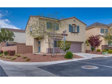 Charming two-story home featuring a well-manicured front yard with desert landscaping and inviting curb appeal at 7919 Mineral Peak St, Las Vegas, NV 89166