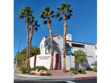 Santa Margarita Condominiums exterior view with palm trees and well-maintained landscaping at 1621 Sandecker Ct # 104, Las Vegas, NV 89146