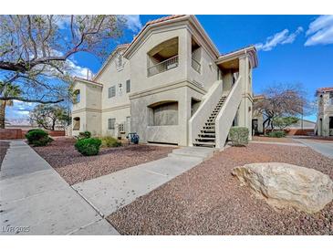 Attractive two-story condo with landscaped front and stairs to the second floor entry at 1881 W Alexander Rd # 1135, North Las Vegas, NV 89032