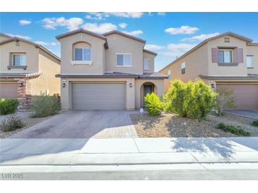 Two-story home featuring a two-car garage, neutral stucco, and low-maintenance landscaping at 2878 Chalk Mountain Ct, Las Vegas, NV 89142