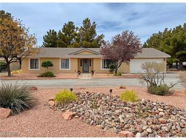 Charming home featuring desert landscaping with rock features and a well-maintained front yard at 3580 Unicorn Ave, Pahrump, NV 89048