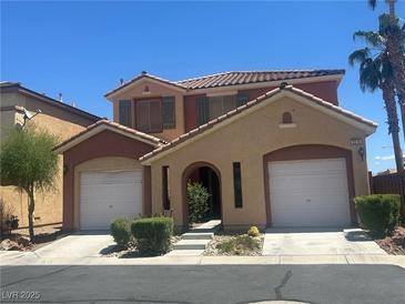 Charming two-story home with a well-maintained front yard, two-car garage, and desert landscaping at 5518 Ovando Way, Las Vegas, NV 89122