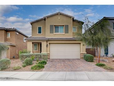 Charming two-story home with a paved driveway, complemented by manicured landscaping and a neutral color scheme at 7109 Red Gulch St, North Las Vegas, NV 89084