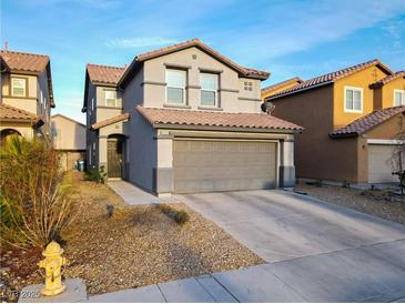 Charming two-story home features a neutral exterior, well-kept landscaping, and an attached two-car garage at 8532 Caddy Corner St, Las Vegas, NV 89139