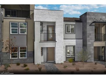 Modern three-story townhome featuring stone accents, private balconies, and a well-maintained front yard at 890 Apatite Pl # Lot 68, Henderson, NV 89011