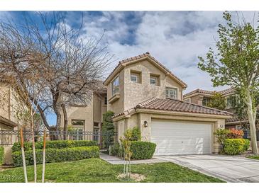 Charming two-story home featuring a well-manicured lawn and a two-car garage at 916 Pro Players Dr, Las Vegas, NV 89134