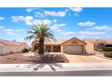 Charming single-story home with a well-manicured front yard and a mature palm tree, set under a bright blue sky at 9305 Quail Ridge Dr, Las Vegas, NV 89134