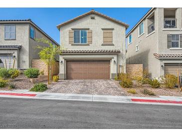 Two-story home with tan stucco, brown garage door and shutters, and brick paved driveway at 10650 Sariah Skye Ave, Las Vegas, NV 89166