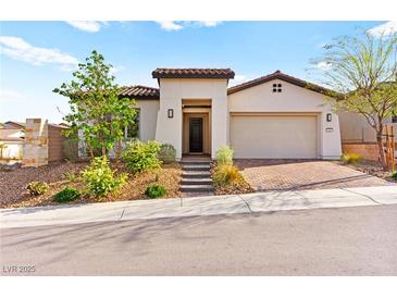 Charming single-story home featuring a well-manicured front yard and a two car garage at 31 Autumn Palm Ave, Henderson, NV 89011