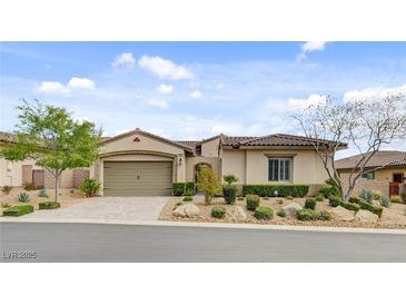 Charming single-story home with a two-car garage and beautiful desert landscaping at 730 Puerto Real Ct, Las Vegas, NV 89138