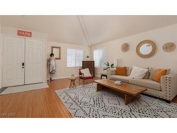 Bright living room with hardwood floors, neutral decor and natural light at 2691 Rimpacific Cir, Las Vegas, NV 89146
