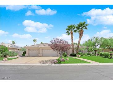 Charming single-story home showcasing a well-manicured lawn, lush greenery, and a three-car garage at 4722 Blue Mesa Way, Las Vegas, NV 89129