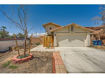 Charming two-story home with a two-car garage and desert landscaping in a bright, sunny setting at 100 Underhill Ct, Las Vegas, NV 89145