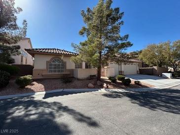 Charming single-story home with well-maintained landscaping and a cozy front porch at 10657 San Vercelli Ct, Las Vegas, NV 89141
