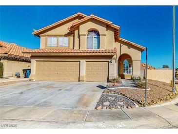 Inviting two-story home with a well-manicured yard, desert landscaping, and a two-car garage at 1532 Ascension Cir, North Las Vegas, NV 89031