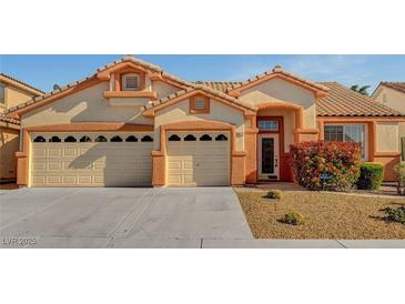 Charming single-story home with a three-car garage, tidy landscaping, and a warm, inviting entrance at 3071 Misty Moon Ave, Henderson, NV 89052