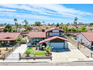 Charming home featuring a red tile roof, landscaped front yard, and an attached two-car garage at 5301 Kalmia Dr, Las Vegas, NV 89103