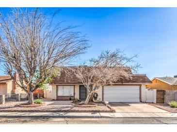 Cozy single-story home featuring desert landscaping, a two-car garage, and a brick-lined driveway at 7176 Fenway Ave, Las Vegas, NV 89147