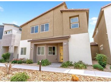Charming two-story home featuring a modern exterior with a yellow front door and low maintenance landscaping at 7476 Opal Star St, North Las Vegas, NV 89084