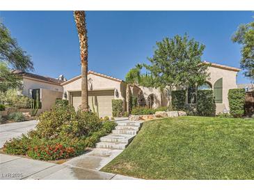 Charming single-story home features a well-manicured lawn, desert landscaping, and inviting entrance at 11540 Snow Creek Ave, Las Vegas, NV 89135