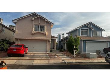 Charming two-story homes with well-maintained exteriors, driveways, and attached garages at 1653 Crystal Shadows Cir, Las Vegas, NV 89119