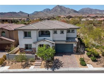 Charming two-story home features a well-manicured lawn, tiled roof, and mountain views at 257 Elder View Dr, Las Vegas, NV 89138